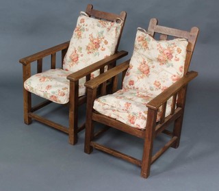 A pair of child's 1930's Arts and Crafts oak reclining armchairs 
