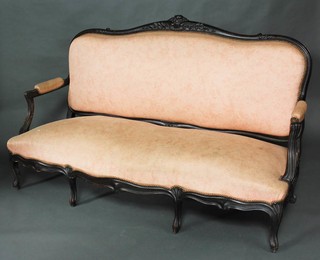 A 19th Century French carved ebonised show frame sofa raised on cabriole supports 109cm x 178cm w x 67cm, upholstered in pink material 