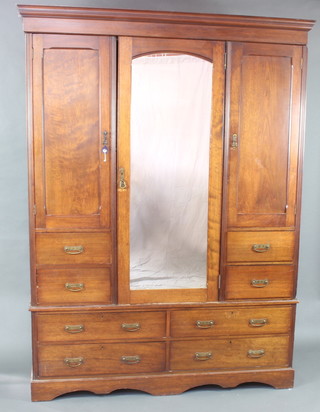 James Shoolbred & Company, an Edwardian Art Nouveau  mahogany wardrobe with moulded cornice, the centre section fitted hanging space enclosed by an arched mirror panelled door  flanked by 2 further cupboards with hanging space enclosed by panelled doors above 4 short drawers the base fitted 4 long drawers 214cm h x 162cm w x 58cm d 