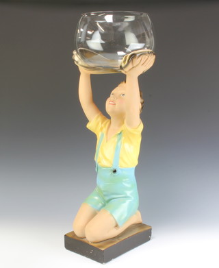 A 1930's Art Deco polychrome plaster figure of a young boy holding a loft a clear glass bowl 70cm 
