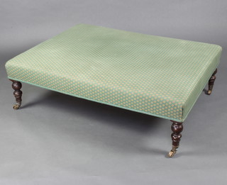A Victorian style rectangular stool, raised on turned supports with brass caps and castors 57cm h x 124cm w x 93cm d 