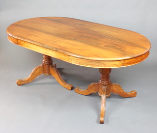 A Georgian style hardwood oval dining table raised on twin pillar and tripod supports 76cm h x 182cm l x 106cm w