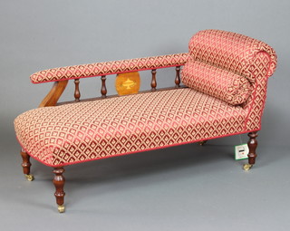 A Victorian style mahogany chaise longue complete with bolster, upholstered in red material and raised on turned supports 66cm h x 120cm w x 52cm d 