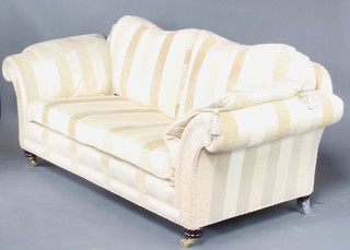 A Georgian style 2 seat sofa upholstered in gold and cream striped material and raised on bun feet 85cm h x 222cm w x 90cm