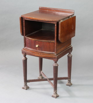 A Georgian style mahogany bow front drop flap bedside cabinet with recess above a drawers, having Corinthian capital decoration to the sides, raised on turned supports 92cm h x 49cm w x 43cm d 