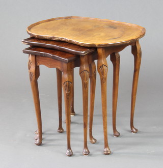 A nest of 3 Queen Anne style kidney shaped interfitting coffee tables raised on cabriole supports 56cm x 60cm x 40cm 
