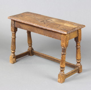 A rectangular carved oak stool raised on turned and block supports 47cm x 70cm w x 28cm d 