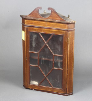 An Edwardian inlaid mahogany hanging corner cabinet with moulded cornice, fitted shelves enclosed by an astragal glazed panelled door 70cm h x 50cm w x 27cm d 