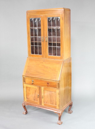 An Edwardian inlaid mahogany bureau bookcase, the shelved upper section enclosed by lead glazed panelled doors, the base fitted a fall front revealing a well fitted interior above 1 long drawer with cupboard beneath, raised on  cabriole supports 191cm h x 75cm w x 46cm d 