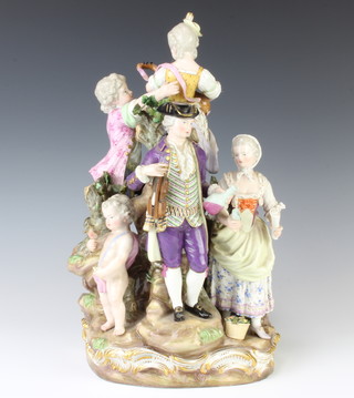 A late 19th Century Meissen group of a gentleman, lady, 2 children and 2 putti around a rock, the gentleman holding a violin and a decanter, the lady holding a cup and sheet music, 1 of the putti sitting astride a goat and the children playing a musical instrument, raised on a Rococo base with underglazed mark 35cm 
