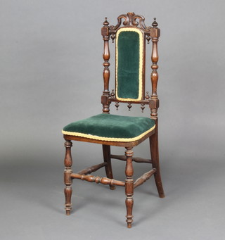 A Victorian simulated rosewood nursing chair, the seat and back upholstered in blue material, raised on turned supports 