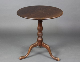 A 19th Century circular mahogany tea table raised on a turned column and tripod base 69cm h x 65cm diam. 