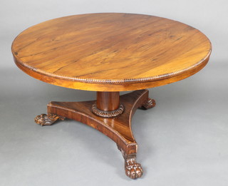 A William IV circular rosewood snap top breakfast table raised on a turned column and triform base with paw feet 70cm h x 128cm diam. 