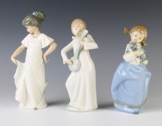 A Nao figure of an angel 19cm, ditto of a girl with puppy 18cm and a young lady 22cm 