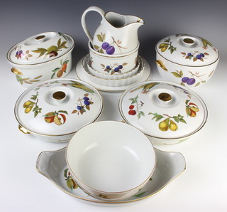 A quantity of Royal Worcester Evesham dinner ware comprising 4 tureens and covers, fruit bowl, a pie dish, jug, soufle, 2 flan dishes, cake stand and 2 boxed sets of place mats 