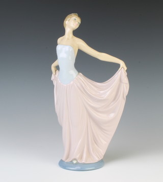 A Lladro figure of a lady holding aloft her dress 30cm 