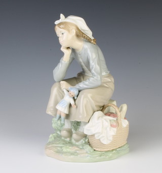 A Lladro girl with doll and basket 20cm
