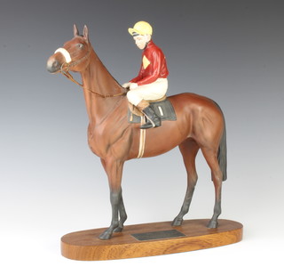 A Beswick Connoisseur model - Red Rum, Brian Fletcher up, raised on a wooden base 30cm 