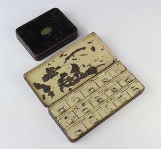 A Hardy 1920's dry fly box fitted 9 compartments, containing various fishing flies together with a similar black Japanned box with 15 compartments and various flies 