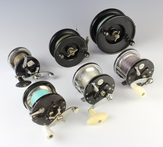 An Alcock aerial black bakelite and chrome centre pin fishing reel, 1 other, a Penn no.85 sea fishing reel, 2 no.112 Ocean City sea fishing reels and an Intrepid sea fishing reel  