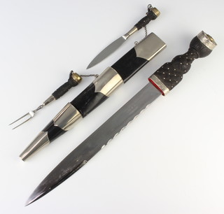 A Scots Guards' pipers dirk and scabbard, the 13.5cm blade marked 973-6901 with broad arrow marked 1983, the scabbard also marked 973-6901 H1985 and with broad arrow, complete with knife and fork and scabbard, reputedly the property of Major T S Spicer 