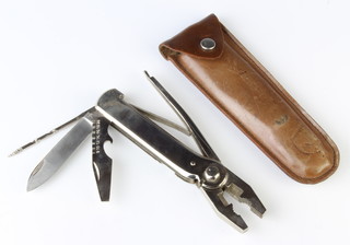 A French Brevet Electric multi-bladed tool incorporating pliers, screwdriver, gimlet and knife, the blade marked Made in France, contained in a leather pouch