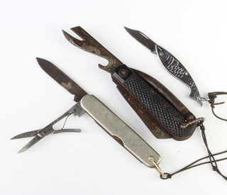William Rogers of Sheffield, a military style folding knife with Merlin spike, blade and tin opener marked William Rogers Sheffield together with a Continental folding pocket knife with 2 blades and scissors, steel grip and a folding pocket knife the grip in the form of a fish 