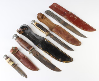 William Rogers of Sheffield, a knife with 13cm blade and simulated horn grip, contained in an associated scabbard, a Schur Inc Japanese bowie style knife with 12cm and horn grip contained in a leather scabbard together with 2 other bowie style knives 