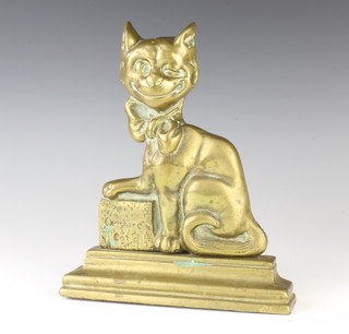 A 19th Century brass door stop in the form of the seated Cheshire Cat 25cm x 21cm x 4cm 