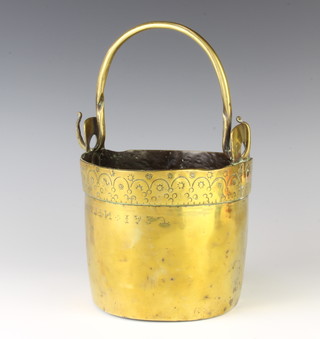 A curious 18th Century Continental brass pail with swing handle engraved A.I.Covsin. 1732?, the base with pierced holes, 17cm h x 16cm diam. 