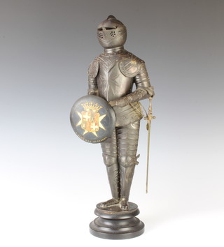 A 1920's pressed metal model of a standing Knight of Malta, the reverse of the shield marked C Galdies Str Mezzodi Dec 1926 43cm h x 10cm diam. 