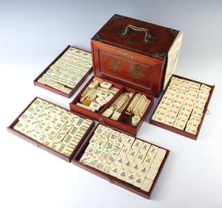A bone and bamboo Mahjong set contained in a mahogany and metal mounted case fitted 5 long drawers 