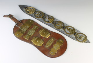 An oval shaped brown leather martingale with 5 brass plaques decorated a locomotive, 2 in the form of barrels, 1 decorated a swan, 1 marked Staddon makers St Phillips Bristol and 1 marked  Benjamin makers Swansea together with 1 other martingale hung reproduction horse brasses 