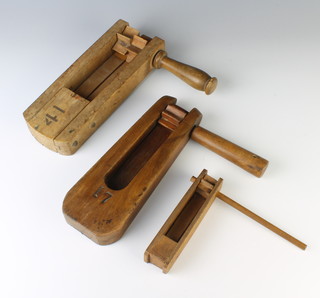 A wooden rattle marked D.U.D.C impressed with George VI royal cypher, 1 other wooden rattle marked 17, a child's small rattle marked 1946 a peace celebration souvenir 
