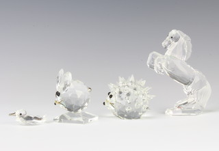 A Swarovski Crystal figure of a stallion 10cm, ditto hedgehog 5cm, a mouse 6cm and duck 4cm 