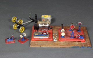 A Mamod stationary steam engine and 8 various machines raised on a wooden board
