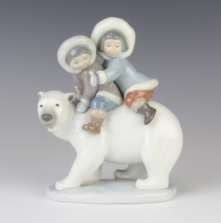 A Lladro figure of 2 children riding a polar bear 5353 18cm