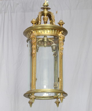 A gilt metal cylindrical hall lantern with swag decoration and glass panels 53cm h x 21cm diam. 
