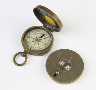 An automatic dice shaker contained in a circular case marked patent C H & Sons together with a marching compass 