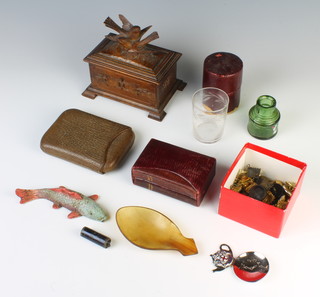 A carved oak trinket box the lid decorated 2 birds raised on bracket feet, 13cm x 15cm x 10cm, a collection of  military pips, buttons, horn spoon, leather cigar case, glass beaker in a leather case and other curios