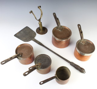 4 copper saucepans with lids and iron handles and 1 other, a brass "compass" mount and a polished steel bakers peel 