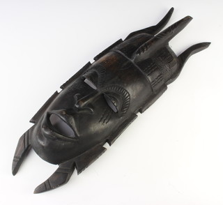 A carved African hardwood mask 57cm x 17cm 