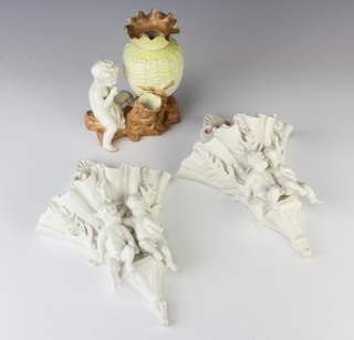 A pair of Victorian white glazed wall pockets decorated with figures amongst ferns 28cm together with a Moore Brothers vase with a child sitting beside a basket weave urn 18cm 