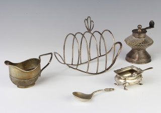 A stylish silver 5 bar toast rack Birmingham 1896, a cream jug, salt, 2 spoons and a silver mounted pepper mill 