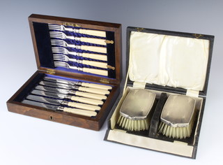 A cased pair of gentleman's silver engine turned hair brushes Birmingham 1955 and a cased set of 6 dessert eaters 