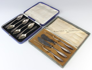 A cased set of 6 silver plated grapefruit spoons and a cased pair of eaters 
