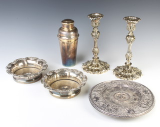 A pair of Victorian silver plated foliate candlesticks 26cm, a cocktail shaker, pair of coasters and repousse dish 