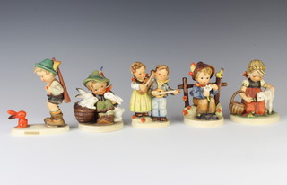 A Goebels figure of a boy with bunnies 58/0 11cm, a ditto Sensitive Hunter 6/0 13cm, 2 singing children 150 2/0 11cm, a boy by a gate 174 10cm and favourite pet 361 11cm 