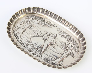 A repousse silver oval dish decorated with fete gallant scene 15cm, rubbed marks, 90 grams 