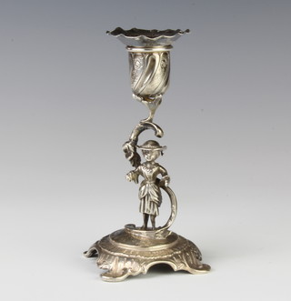 A Continental repousse silver chamber stick with a figural base raised on rococo feet, import mark London 1901, 156 grams, 14cm 